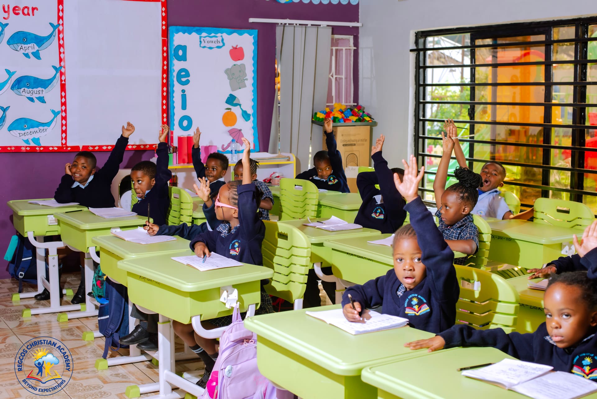 Pupils raising their hands to answer a question in class