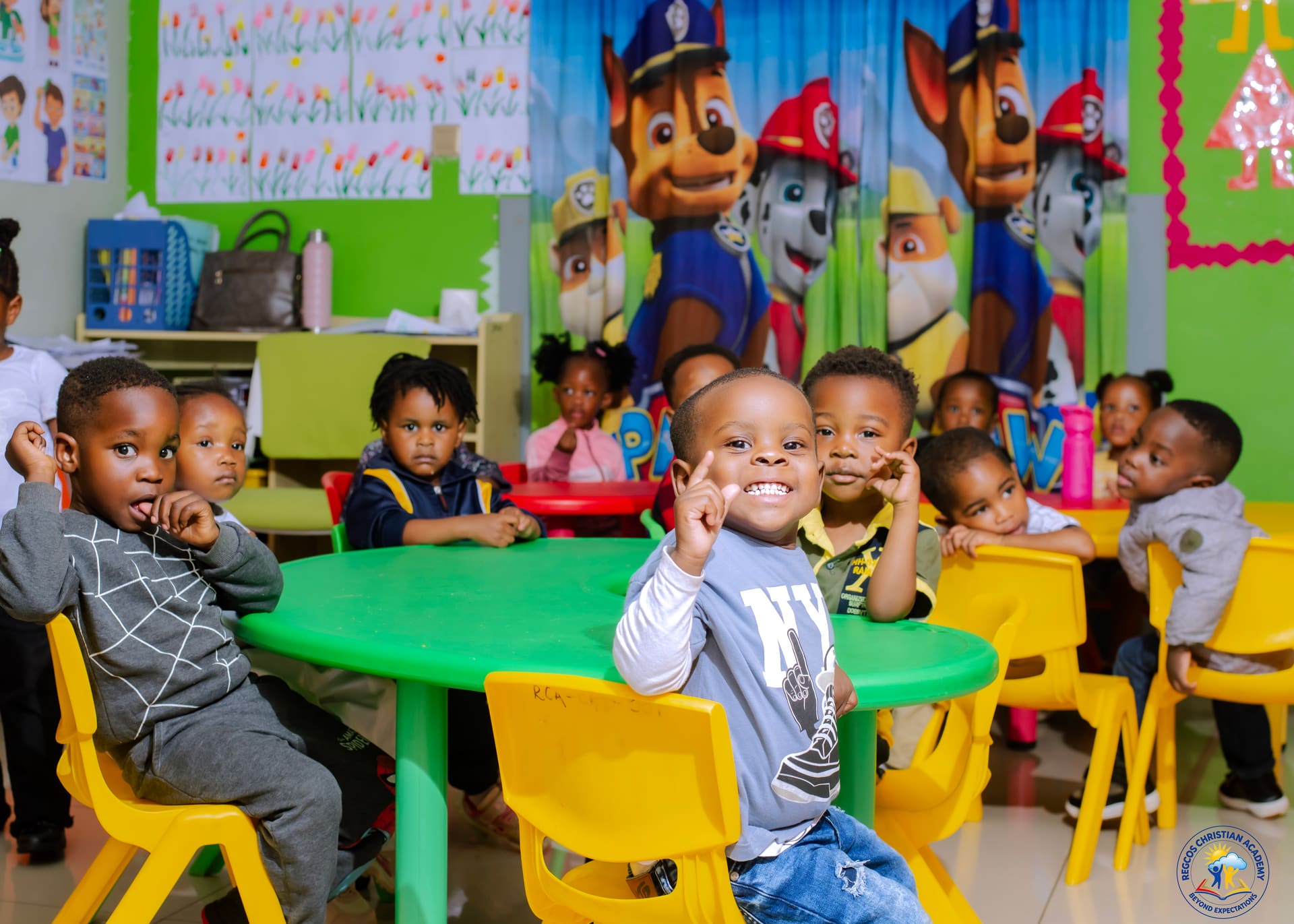 Young children gathered around a table in the early years classroom