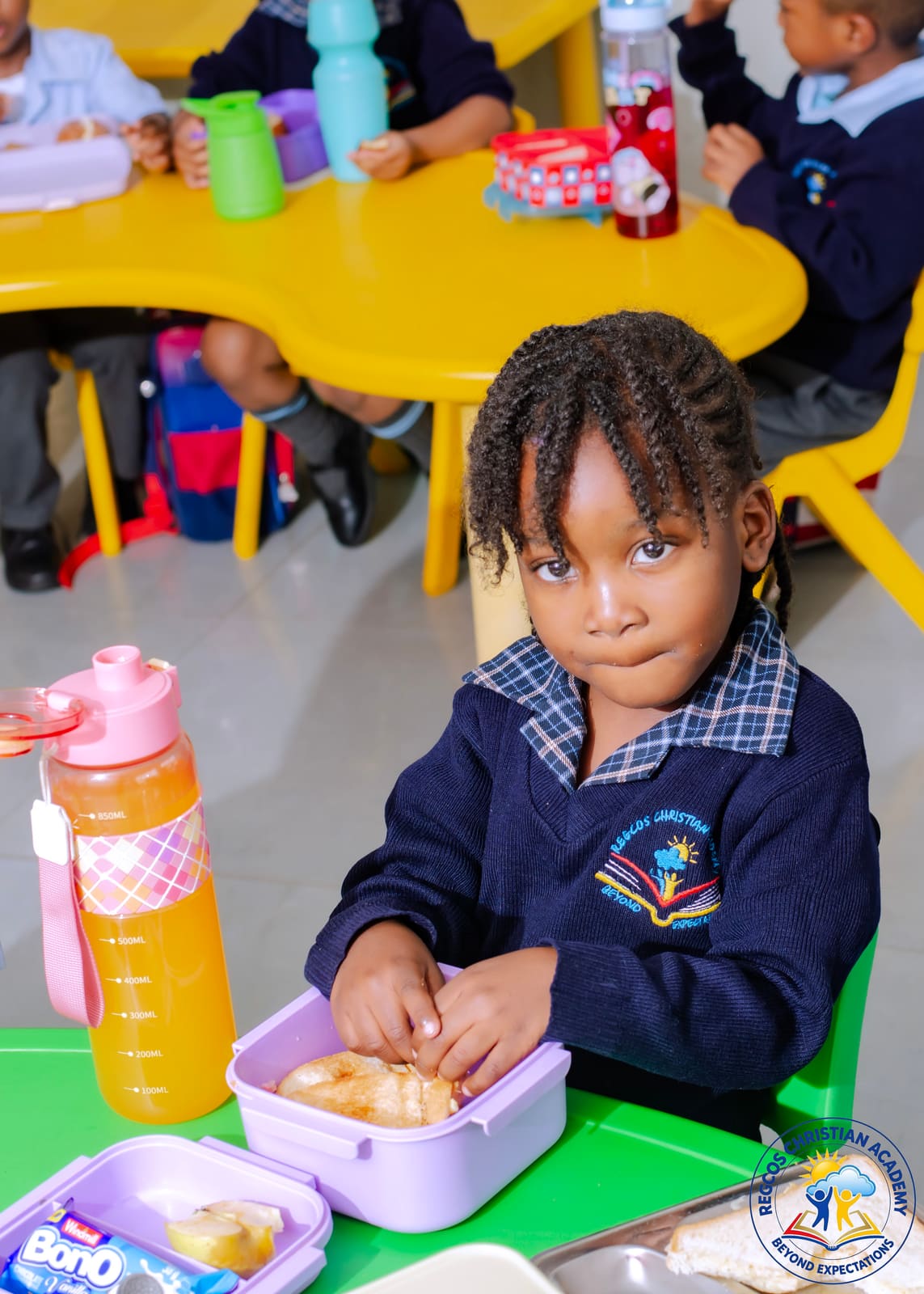 A pupil opening her lunch box at school