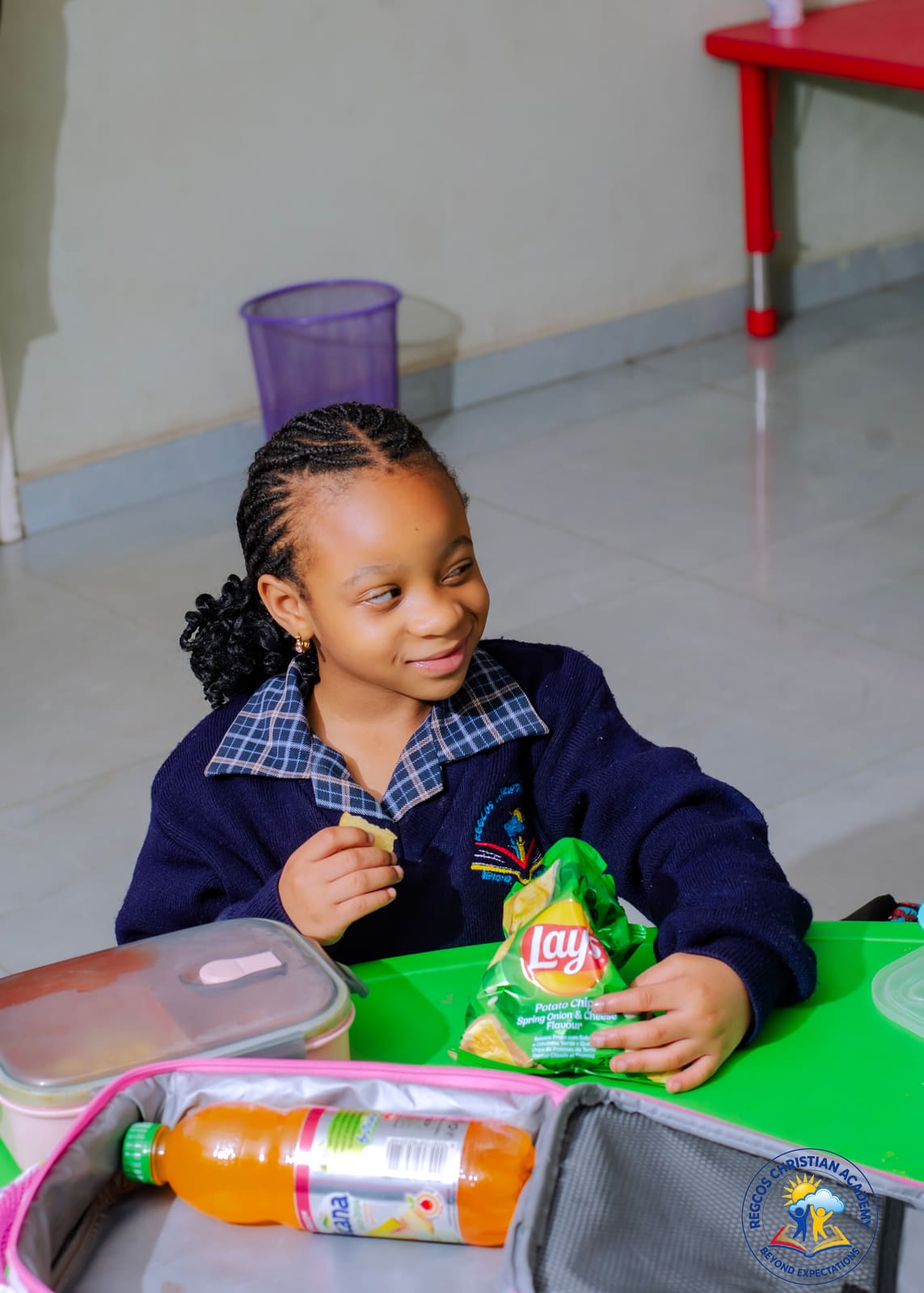 A pupil enjoying a snack during the lunch break